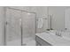 Modern bathroom featuring a glass-enclosed shower with marble-look tiles and a sleek vanity at 2924 Watering Hole Way, Apex, NC 27502