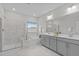 A bright bathroom featuring double vanities, marble tile shower, and a soaking tub at 2924 Watering Hole Way, Apex, NC 27502