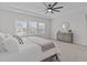 Bright bedroom features a ceiling fan and a window offering natural light and neighborhood views at 2924 Watering Hole Way, Apex, NC 27502