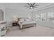 Bedroom with tray ceiling, ceiling fan, neutral decor, and view of the neighborhood at 2924 Watering Hole Way, Apex, NC 27502