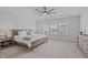 Spacious bedroom with a large ceiling fan, neutral decor and a view of the neighborhood at 2924 Watering Hole Way, Apex, NC 27502