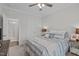 Well-lit bedroom featuring a stylish bed and a glimpse into the en-suite bathroom at 2924 Watering Hole Way, Apex, NC 27502