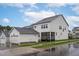 Exterior view of the home with a detached garage and a screened-in porch at 2924 Watering Hole Way, Apex, NC 27502