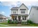 Beautiful two-story home with a welcoming front porch, stone accents and manicured lawn at 2924 Watering Hole Way, Apex, NC 27502