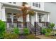 Charming front porch featuring stone accents, landscaping, and a cozy seating area at 2924 Watering Hole Way, Apex, NC 27502