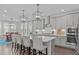 Spacious kitchen with island seating, stainless appliances, and pendant lighting above the island at 2924 Watering Hole Way, Apex, NC 27502