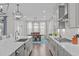 Modern kitchen with stainless appliances, gray cabinets, quartz countertops, and an eat-in dining area at 2924 Watering Hole Way, Apex, NC 27502