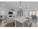 Open floor plan kitchen with a view to living and dining areas; stainless steel appliances at 2924 Watering Hole Way, Apex, NC 27502