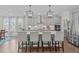 Kitchen with island seating, stainless appliances, stylish pendant lighting, and gray cabinets at 2924 Watering Hole Way, Apex, NC 27502