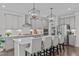 Modern kitchen featuring seating at the island, stainless appliances, and stylish pendant lighting at 2924 Watering Hole Way, Apex, NC 27502