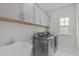 Well-lit laundry room with modern appliances and ample storage at 2924 Watering Hole Way, Apex, NC 27502