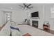 Bright living room features a fireplace, ceiling fan, and comfortable sectional couch at 2924 Watering Hole Way, Apex, NC 27502