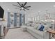 Open-concept living room and kitchen with a large, comfortable sectional and modern lighting at 2924 Watering Hole Way, Apex, NC 27502