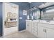 Blue bathroom featuring double sink vanity and an entrance to the main bedroom at 306 Crossland Dr, Chapel Hill, NC 27517