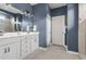 Blue bathroom with white vanity and sink featuring decorative mirror and lighting at 306 Crossland Dr, Chapel Hill, NC 27517
