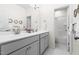 Bright bathroom with a double vanity, modern fixtures, and a large mirror at 306 Crossland Dr, Chapel Hill, NC 27517