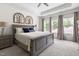 Main Bedroom with neutral carpet, tray ceiling, lamps and window views at 306 Crossland Dr, Chapel Hill, NC 27517