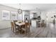 Open dining and kitchen area with hardwood floors, great natural light, and stainless steel appliances at 306 Crossland Dr, Chapel Hill, NC 27517