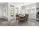 Charming dining area with natural light, modern chandelier, and access to the outdoor porch at 306 Crossland Dr, Chapel Hill, NC 27517