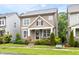 Charming two-story home with stone accents, inviting front porch, and well-maintained landscaping at 306 Crossland Dr, Chapel Hill, NC 27517