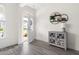 Bright foyer with stylish decor, wood floors, and an open view to the front door and porch at 306 Crossland Dr, Chapel Hill, NC 27517