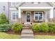Inviting front porch with seating and stone details, perfect for relaxing and enjoying the outdoors at 306 Crossland Dr, Chapel Hill, NC 27517