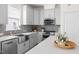 Beautiful kitchen with gray cabinets, stainless steel appliances, mosaic tile backsplash, and a farmhouse sink at 306 Crossland Dr, Chapel Hill, NC 27517