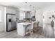Open-concept kitchen featuring gray cabinets, a large island with seating, and modern stainless steel appliances at 306 Crossland Dr, Chapel Hill, NC 27517