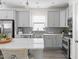 Modern kitchen with gray cabinets, stainless steel appliances, and a stylish backsplash at 306 Crossland Dr, Chapel Hill, NC 27517