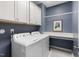 Well-organized laundry room with modern washer and dryer, storage cabinets, and counter space at 306 Crossland Dr, Chapel Hill, NC 27517