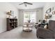 Inviting living room with neutral carpet, ceiling fan, bookshelf and two comfortable armchairs at 306 Crossland Dr, Chapel Hill, NC 27517