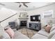 Warm living room featuring a fireplace, staircase, comfy furnishings, plank floors, and modern decor at 306 Crossland Dr, Chapel Hill, NC 27517