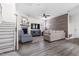 Inviting living room showcasing a cozy fireplace, staircase, stylish furnishings, and plank flooring at 306 Crossland Dr, Chapel Hill, NC 27517