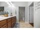 Bathroom showcasing a double vanity, a framed mirror, and access to the walk-in shower at 306 Faith Dr, Gibsonville, NC 27249