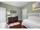 Bright bedroom featuring two beds, hardwood floors, and soft, natural light from a window at 306 Faith Dr, Gibsonville, NC 27249