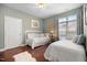 Bright bedroom featuring two beds, hardwood floors, and soft, natural light from a window at 306 Faith Dr, Gibsonville, NC 27249