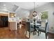 Cozy dining room featuring an elegant light fixture and ample natural light from backyard windows at 306 Faith Dr, Gibsonville, NC 27249