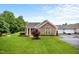 Beautiful home with stone facade, well-kept lawn, and mature landscaping for enhanced curb appeal at 306 Faith Dr, Gibsonville, NC 27249
