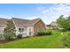 Exterior view of a home with stone accents and a well-manicured lawn at 306 Faith Dr, Gibsonville, NC 27249