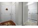 Inviting hallway leading to laundry room with white washer and dryer and ample storage shelves at 306 Faith Dr, Gibsonville, NC 27249