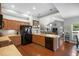 Bright kitchen with a view of the open-concept living area, stainless steel appliances and spacious counters at 306 Faith Dr, Gibsonville, NC 27249
