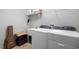 Functional laundry area features modern washer and dryer, sink and plenty of storage space at 306 Faith Dr, Gibsonville, NC 27249