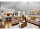 Inviting living room with hardwood floors flows into the modern kitchen with bar seating at 306 Faith Dr, Gibsonville, NC 27249