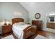 Cozy main bedroom boasts a tray ceiling, a warm color palette, and hardwood flooring at 306 Faith Dr, Gibsonville, NC 27249