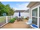 Back patio with outdoor seating, grill, and blue umbrella at 306 Faith Dr, Gibsonville, NC 27249