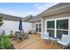 Back patio with outdoor seating, grill, and blue umbrella at 306 Faith Dr, Gibsonville, NC 27249