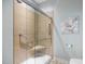 Walk-in shower featuring grab bars, a shower seat, and tile surround at 306 Faith Dr, Gibsonville, NC 27249