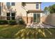 Backyard patio with lawn, small bushes, and brick facade on house at 310 Alamosa Pl, Cary, NC 27519