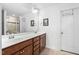 Bathroom features vanity with double sinks, framed mirror and tiled shower at 310 Alamosa Pl, Cary, NC 27519