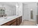 Bright bathroom features a large vanity with double sinks and a wide mirror at 310 Alamosa Pl, Cary, NC 27519